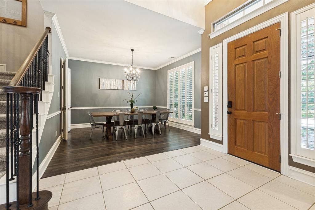 1227 Comanche Drive, Allen, TX 75013 Gracious entryway featuring light-toned tile flooring and a paneled wood-finish door with sidelights