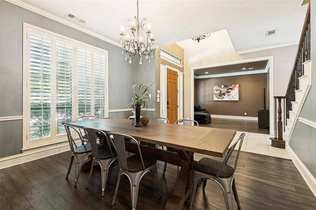 1227 Comanche Drive, Allen, TX 75013 Dining area with a sophisticated dark wood-finish floor and a crystal chandelier