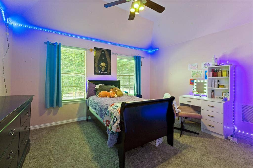 1227 Comanche Drive, Allen, TX 75013 Carpeted room featuring a vaulted ceiling and a ceiling fan with integrated lighting