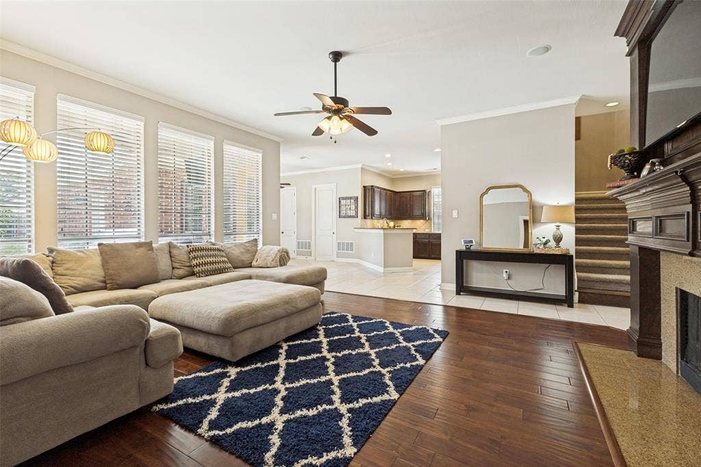 1227 Comanche Drive, Allen, TX 75013 Living area featuring rich wood-finish flooring and multiple tall windows