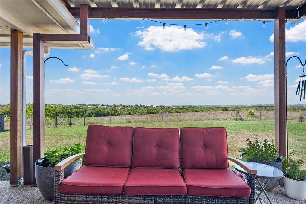 Covered outdoor patio with a metal roof and exposed support beams