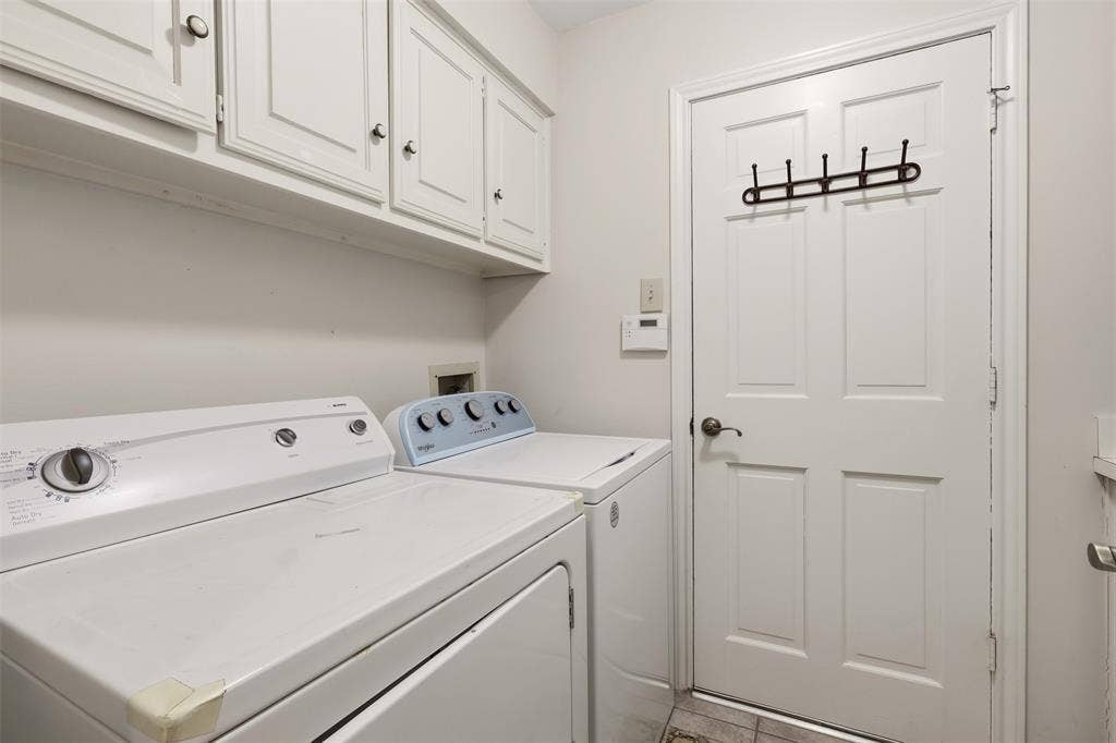 2700 Nighthawk Drive, Plano, TX 75025 White cabinetry, paneled door, and tiled flooring