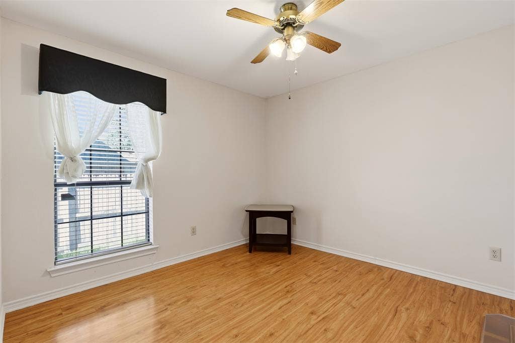 2700 Nighthawk Drive, Plano, TX 75025 Wood-finish flooring, white painted walls, window with horizontal blinds, and a ceiling fan with light fixture