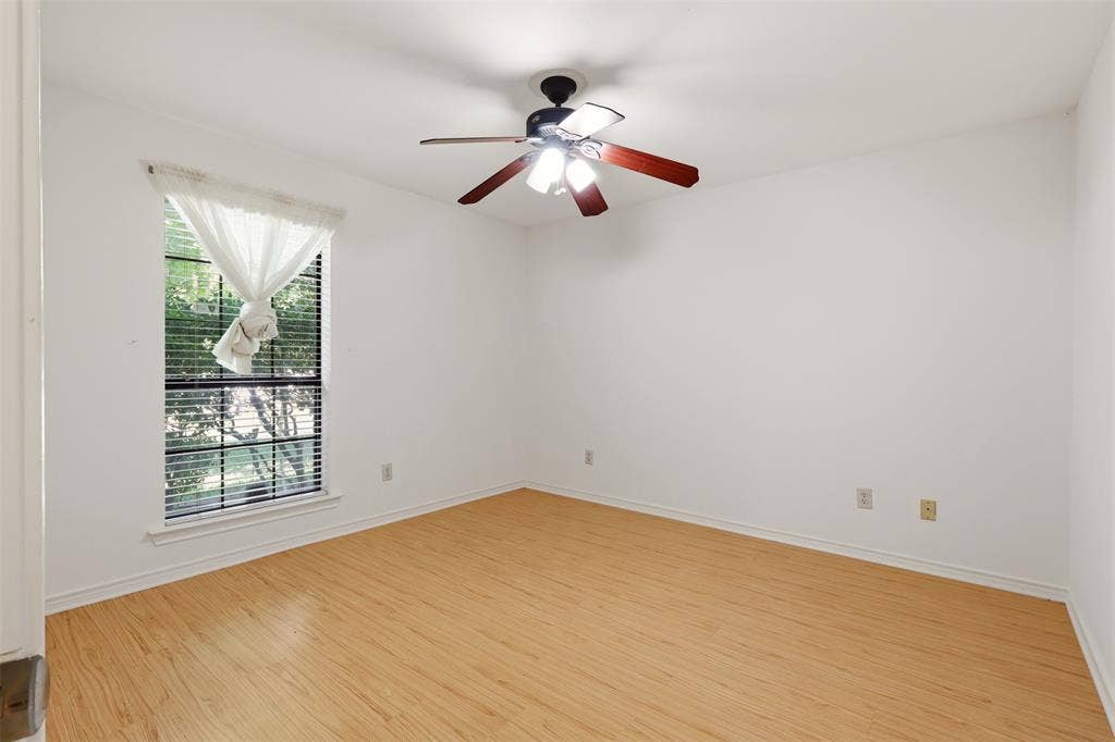 2700 Nighthawk Drive, Plano, TX 75025 Light wood-finish flooring, a window with horizontal blinds, and a ceiling fan with light fixture