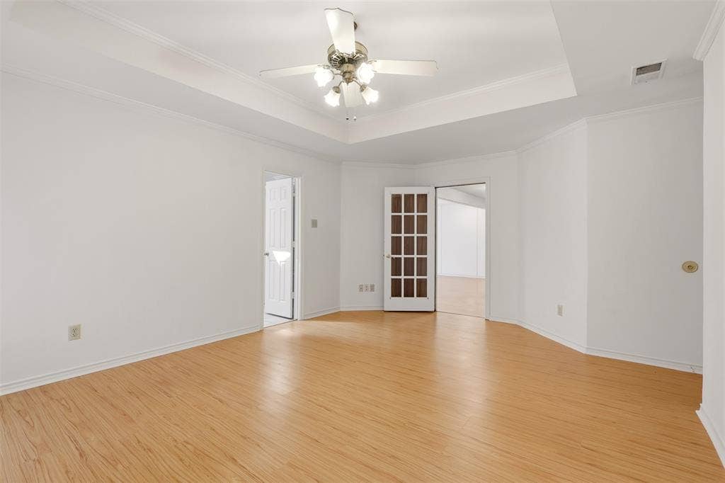 2700 Nighthawk Drive, Plano, TX 75025 Wood-finish flooring, tray ceiling, and a ceiling fan with integrated lighting