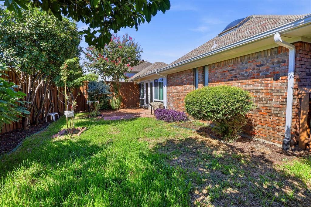 2700 Nighthawk Drive, Plano, TX 75025 Brick exterior with white gutters and a shingle roof