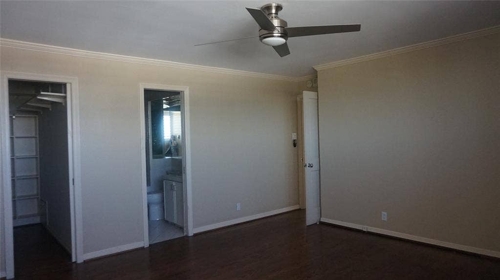 3883 Turtle Creek Boulevard, #1114, Dallas, TX 75219 Wood-finish flooring, crown molding, and a modern ceiling fan with lighting