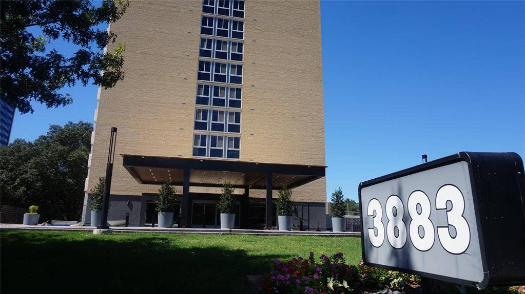 3883 Turtle Creek Boulevard, #1114, Dallas, TX 75219 Brick-clad high-rise featuring multiple windows and a covered entrance
