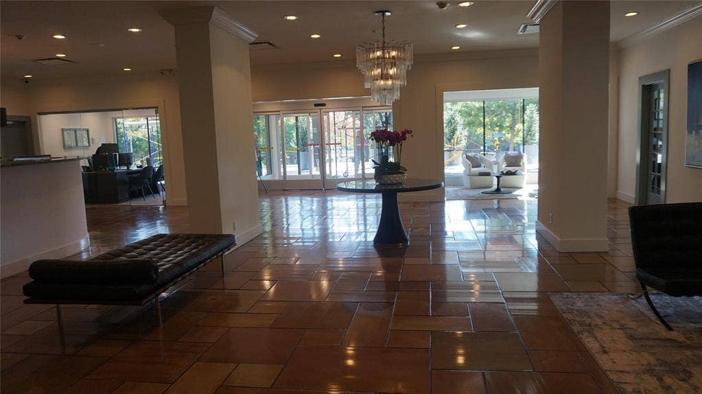 3883 Turtle Creek Boulevard, #1114, Dallas, TX 75219 Spacious common area featuring large format floor tiles, recessed lighting, and a decorative chandelier