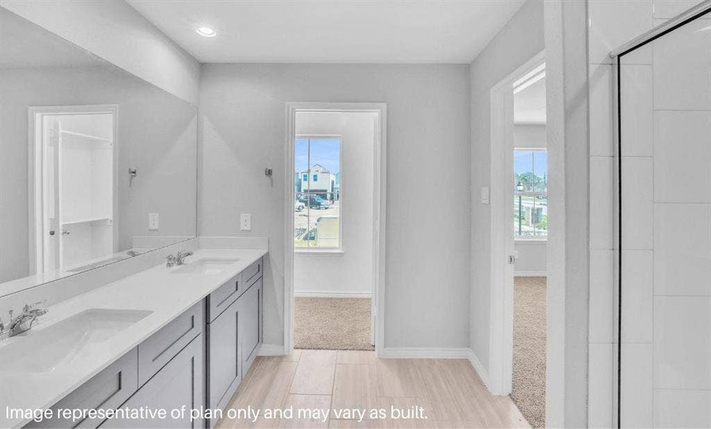 3308 Blue Jay Way, Richland Hills, TX 76118 Double vanity with dual undermount sinks, wall-mounted mirror, recessed lighting, and a walk-in shower with tile surround