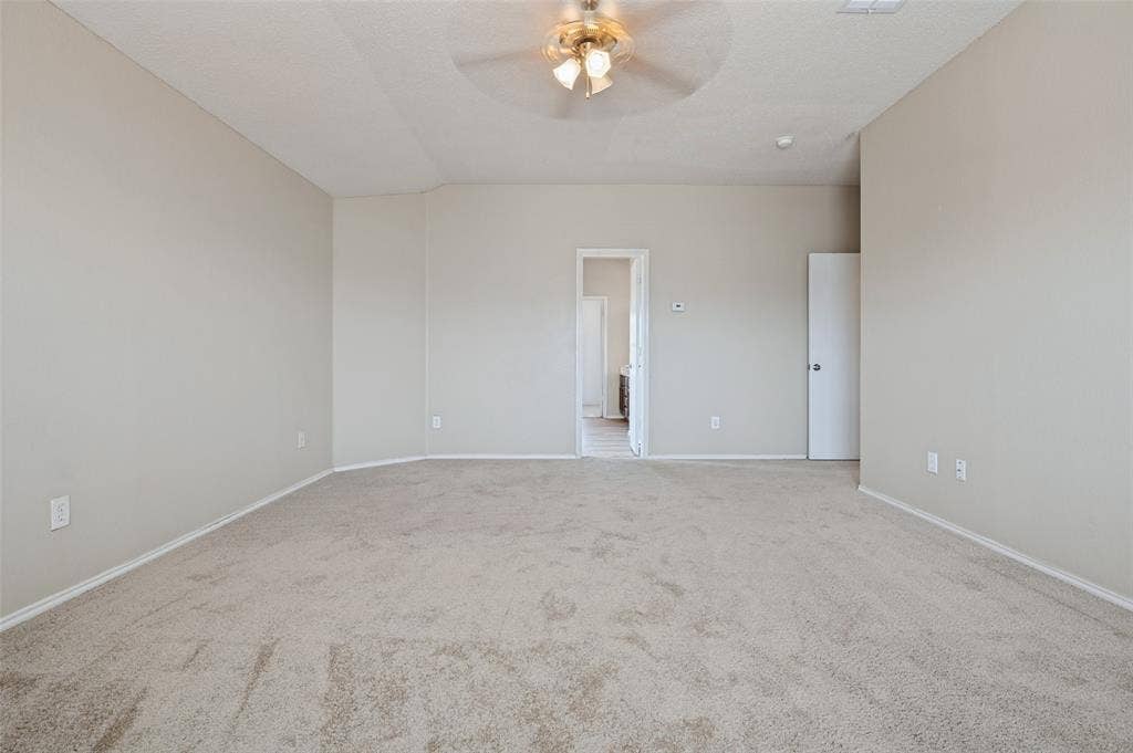 1308 Arbordale Court, Lancaster, TX 75134 Tray ceiling with a decorative ceiling fan, wall-to-wall carpeting, and neutral paint