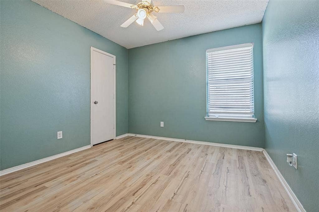 1308 Arbordale Court, Lancaster, TX 75134 Light wood-finish flooring, ceiling fan with light fixture, and window with horizontal blinds