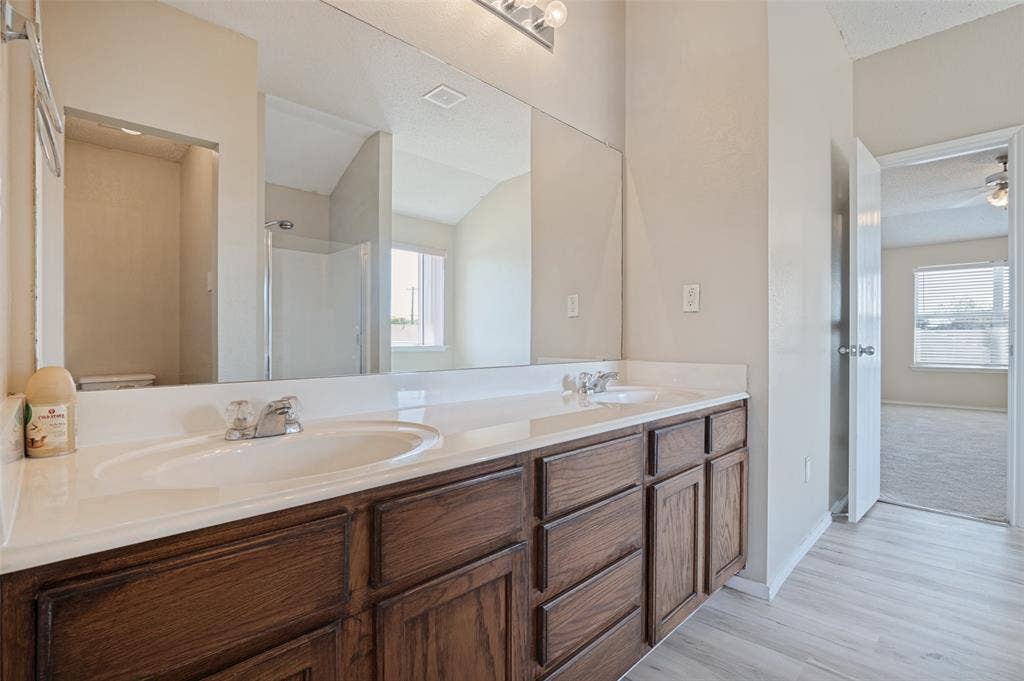1308 Arbordale Court, Lancaster, TX 75134 Dual vanity with wood-finish cabinetry and integrated sinks