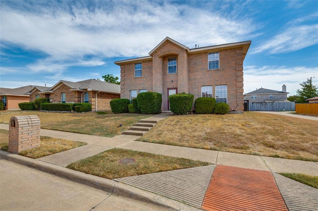 1308 Arbordale Court, Lancaster, TX 75134 Brick exterior featuring multiple windows, a front entry door, and a multi-level sidewalk
