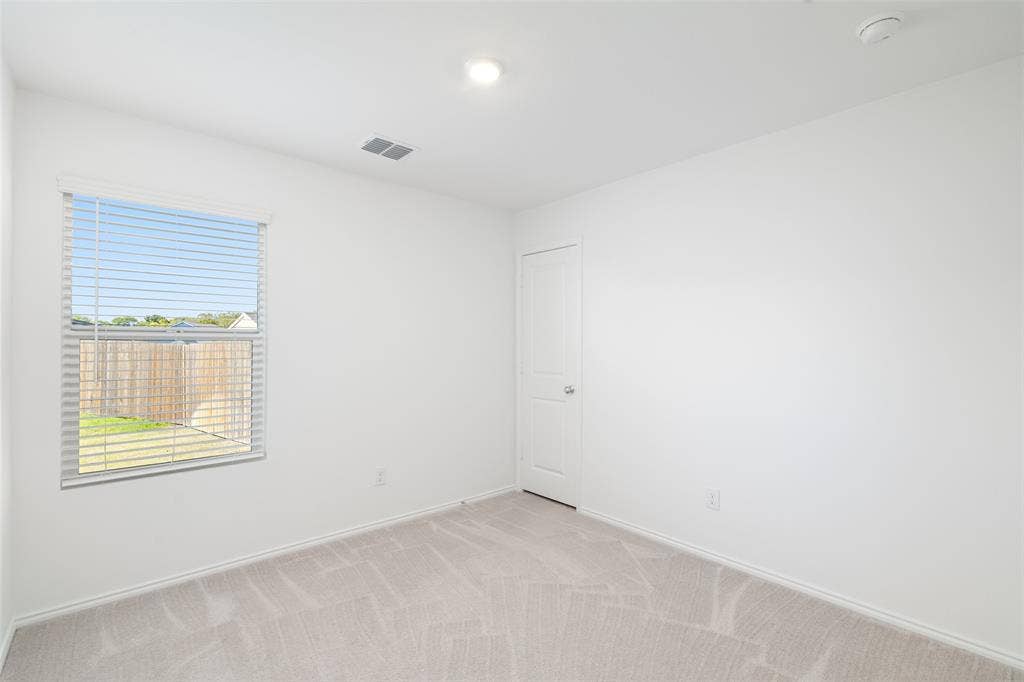250 Herman Lane, Princeton, TX 75407 Neutral-toned carpeting, white painted walls, window with blinds, and recessed ceiling light
