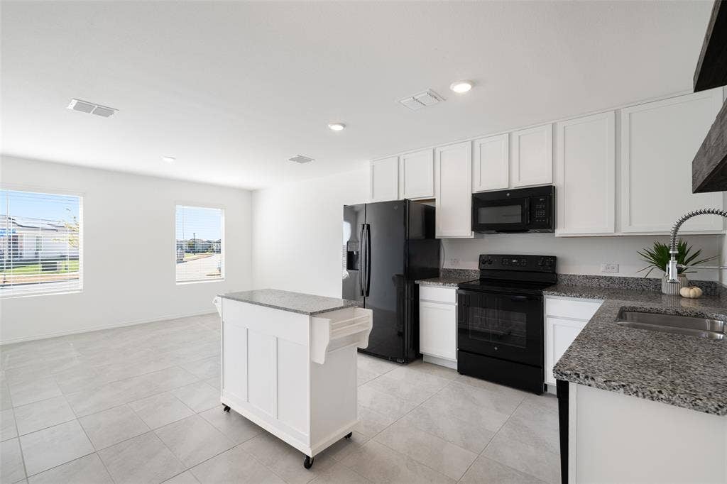 250 Herman Lane, Princeton, TX 75407 Kitchen featuring white cabinetry, granite countertops, black appliances, a stainless steel sink with a pull-down faucet, and tile flooring