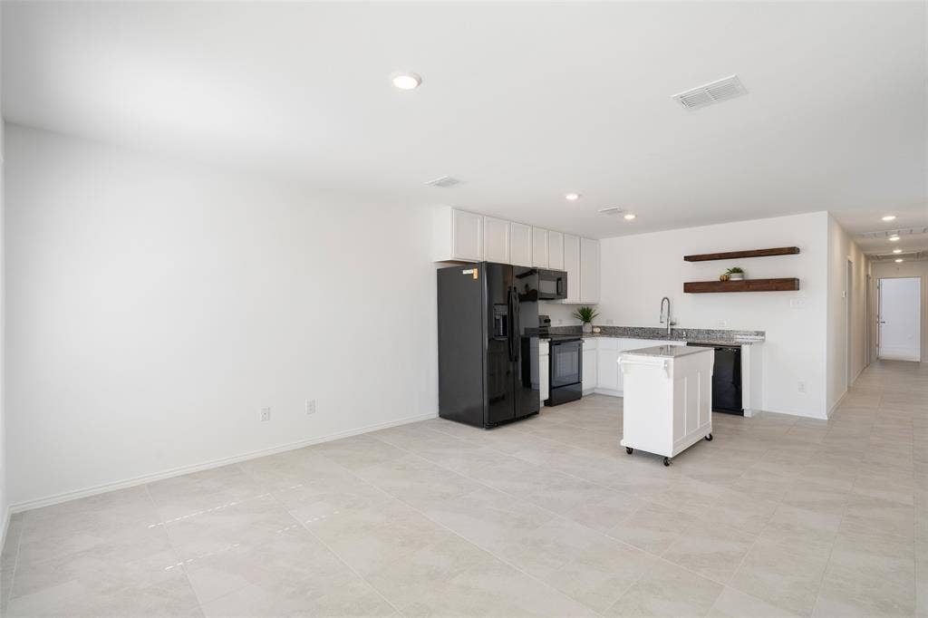 250 Herman Lane, Princeton, TX 75407 Open-concept living area with light-toned tile flooring and recessed lighting