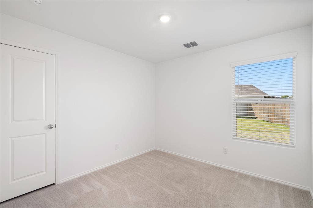 250 Herman Lane, Princeton, TX 75407 Neutral color palette with light gray carpeting, recessed ceiling light, and window with blinds