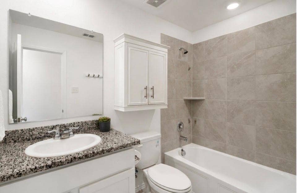 250 Herman Lane, Princeton, TX 75407 Bathroom featuring a single vanity with stone-finish countertop, undermount sink, and polished chrome faucet