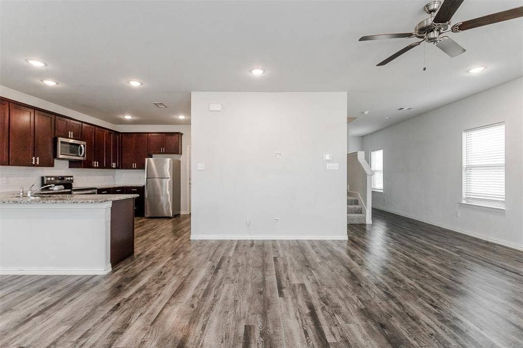 Wood-finish flooring, recessed lighting, and a ceiling fan