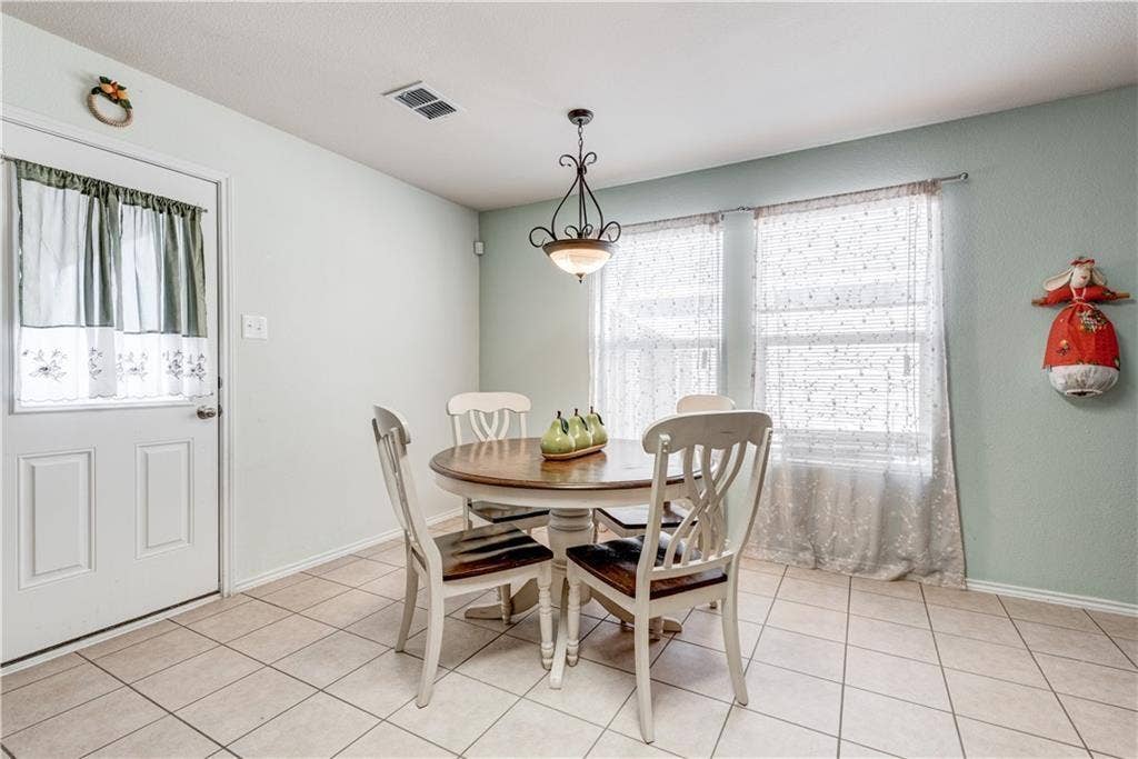 12829 Pricklybranch Drive, Fort Worth, TX 76244 Tile flooring, multiple windows, pendant lighting, and a white paneled door