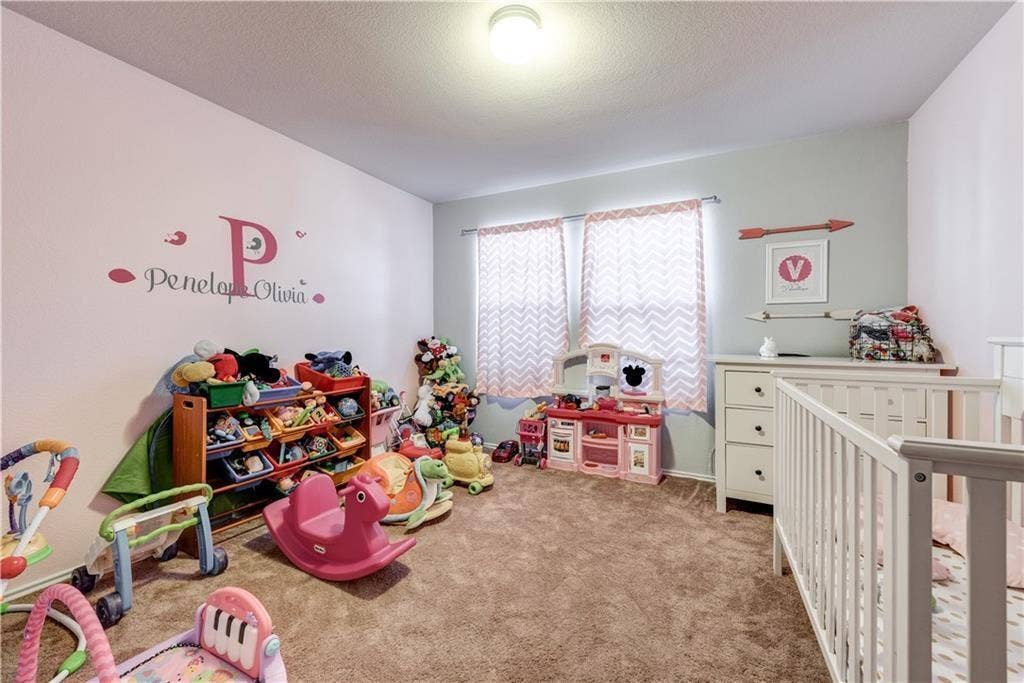 12829 Pricklybranch Drive, Fort Worth, TX 76244 Carpeted room with a ceiling-mounted light fixture and two windows