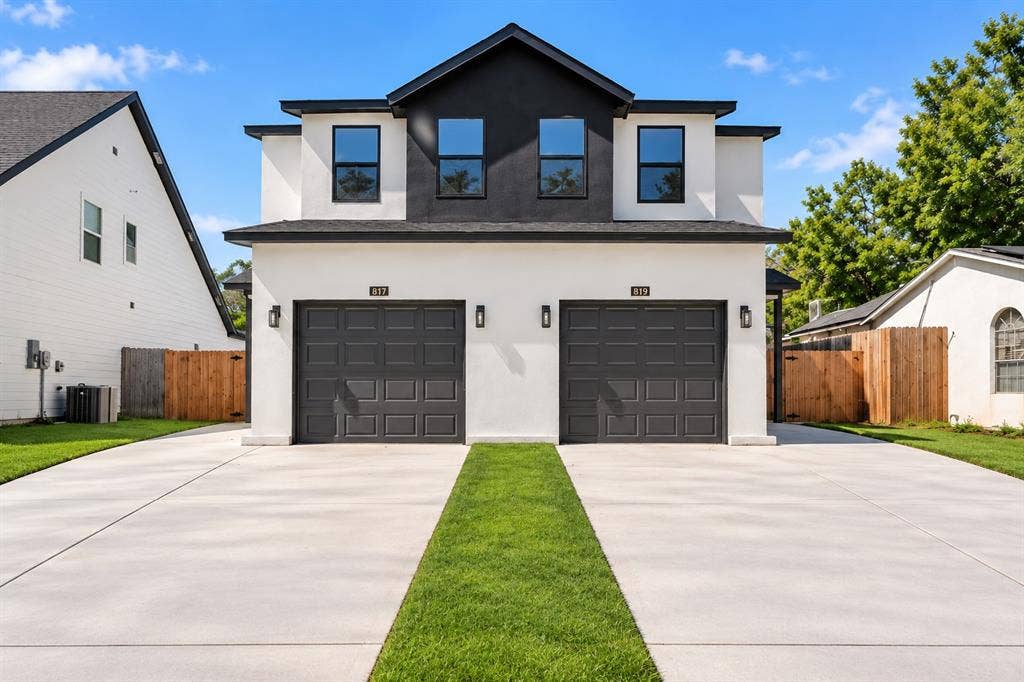 817 Stamps Avenue, Fort Worth, TX 76114 Contemporary duplex exterior with a striking black and white facade, featuring two individual garage doors, dedicated concrete driveways, and manicured lawn accents