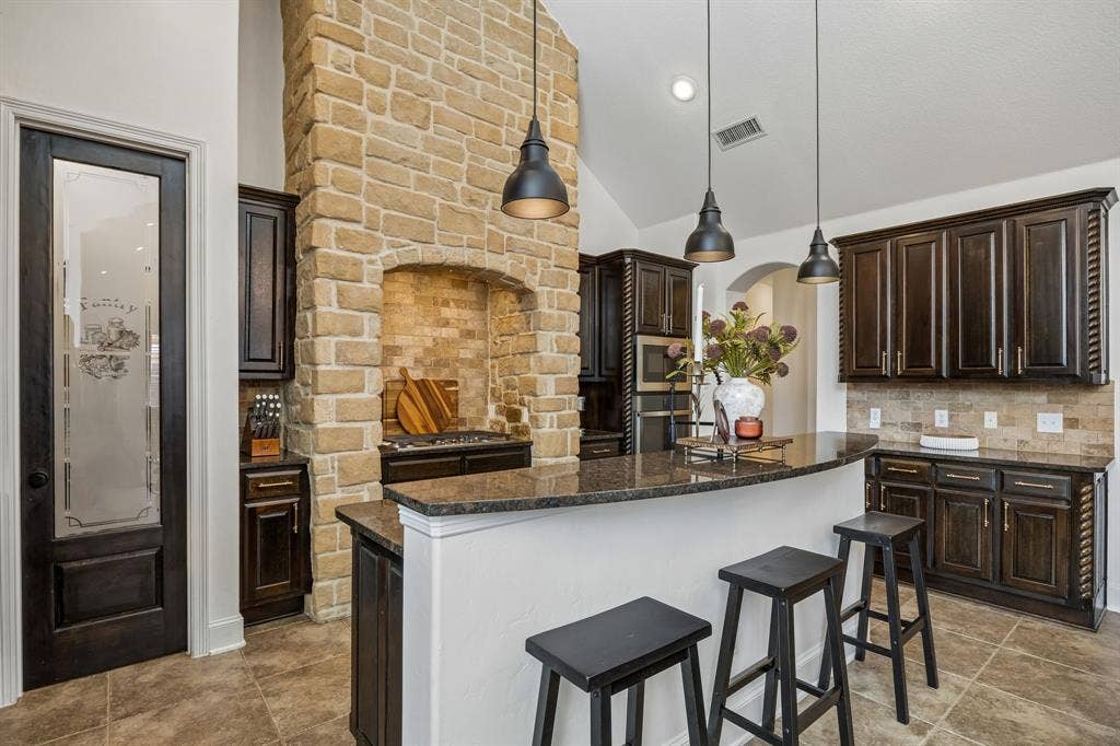 2403 Laguna Lane, Arlington, TX 76012 The gas cooktop is inside of a stone surround.