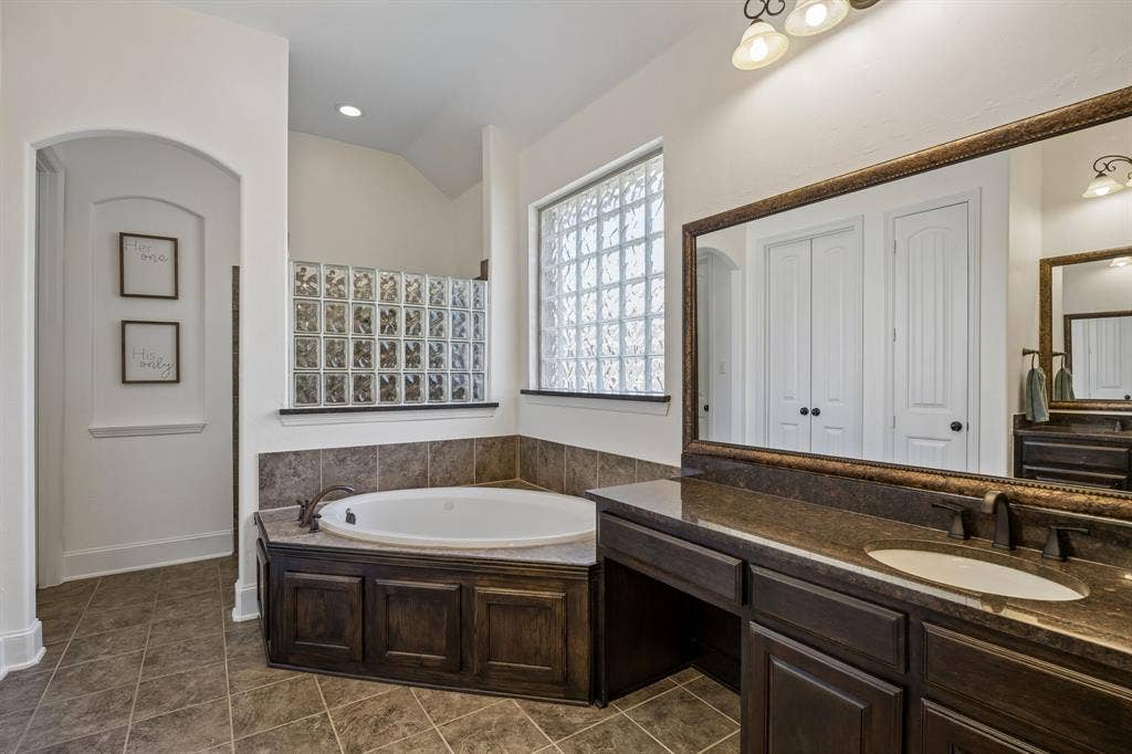 2403 Laguna Lane, Arlington, TX 76012 The ensuite primary bathroom features a soaking tub and separate vanities