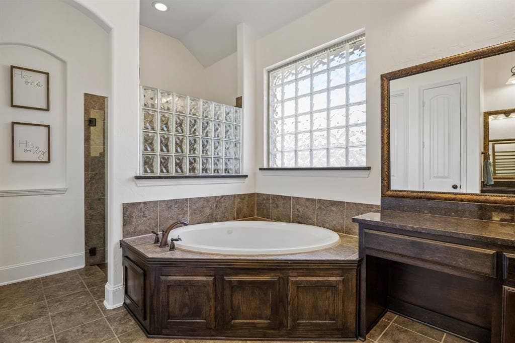 2403 Laguna Lane, Arlington, TX 76012 The separate shower is behind the tub with a frameless glass door.