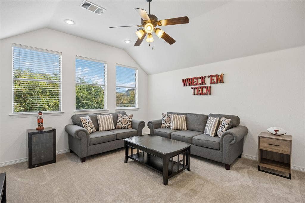 2403 Laguna Lane, Arlington, TX 76012 Upstairs game room with a vaulted ceiling with a fan. This flexible space could also be a bedroom or even a mother in law suite as it has an endure bath and closet.