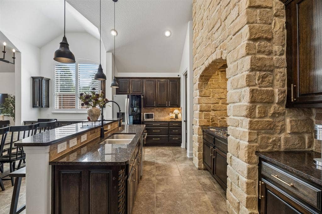 2403 Laguna Lane, Arlington, TX 76012 Here you can see the arched stone surround and the dark cabinetry