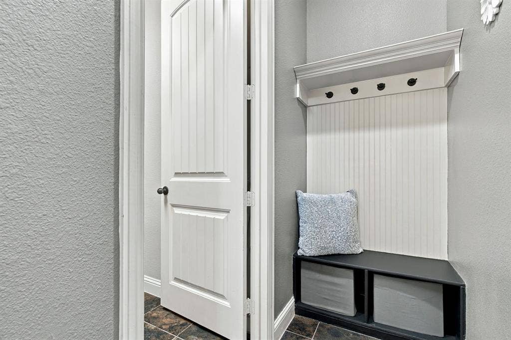 Practical built-in mud room area between the 2-car garage and laundry room—perfect for keeping everyday essentials organized.