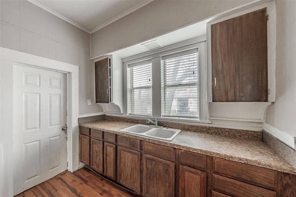 212 N Ruddell Street, Denton, TX 76205 Wood-finish flooring with base cabinetry and a laminate countertop