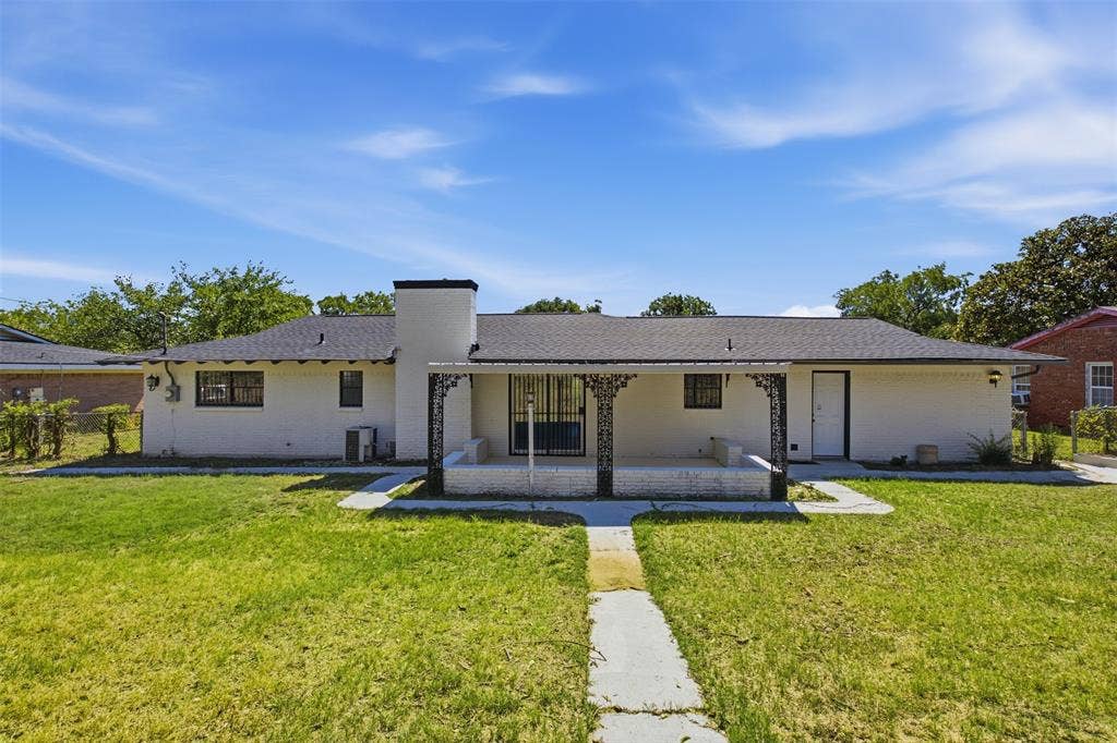 2313 Clearview Drive, Fort Worth, TX 76119 White exterior with a dark shingle roof and a covered patio featuring decorative metal columns