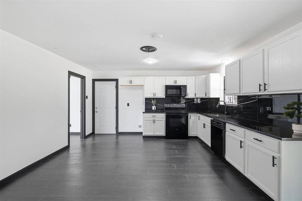 2313 Clearview Drive, Fort Worth, TX 76119 Open-concept kitchen featuring white cabinetry, dark countertops, dark appliances, and dark wood-finish flooring