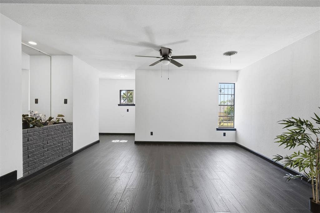 2313 Clearview Drive, Fort Worth, TX 76119 Dark wood-finish flooring, white painted walls, and a ceiling fan with integrated lighting