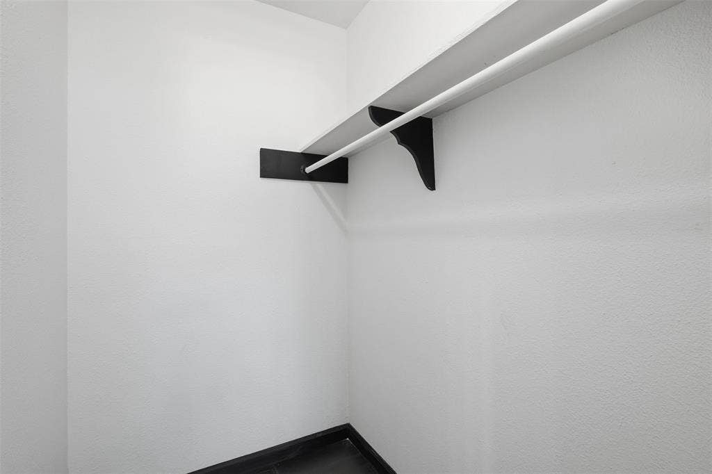 2313 Clearview Drive, Fort Worth, TX 76119 White-painted walls with integrated shelving and hanging rod