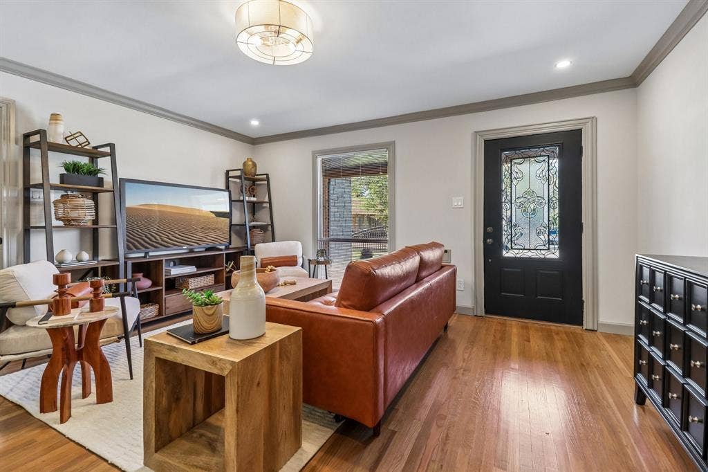Hardwood flooring, recessed lighting, crown molding, a decorative entry door, and a flush mount ceiling fixture