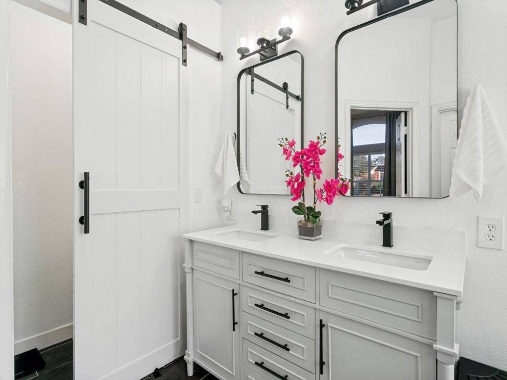 Dual vanity with integrated sinks, white countertop, and matte black fixtures