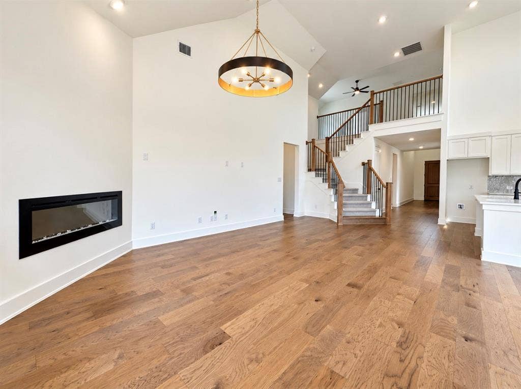 1129 Bradford Street, Celina, TX 75009 Wood-finish flooring throughout, with a linear fireplace