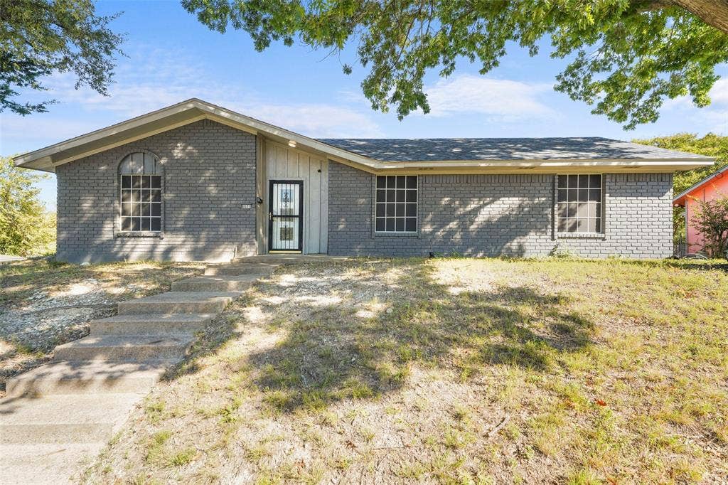 6606 Coleshire Drive, Dallas, TX 75232 Brick exterior with a gabled roofline and concrete steps