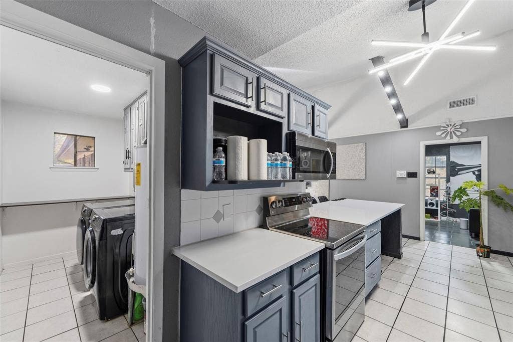 6606 Coleshire Drive, Dallas, TX 75232 Kitchen with gray cabinetry, stainless steel appliances, and white countertops