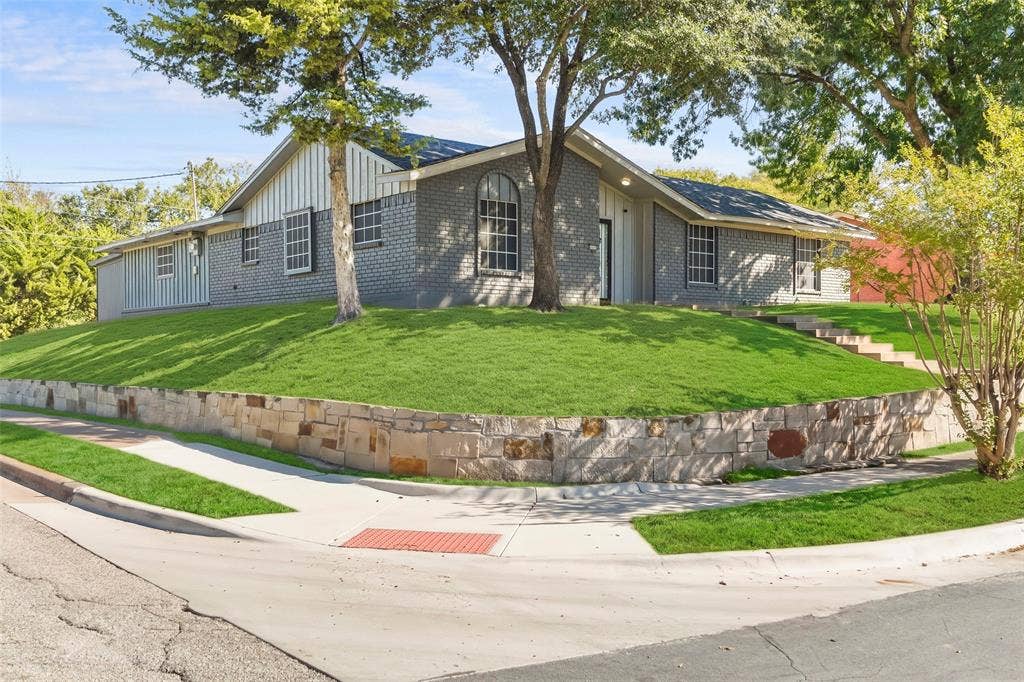 6606 Coleshire Drive, Dallas, TX 75232 Brick and vertical siding exterior with arched and rectangular windows