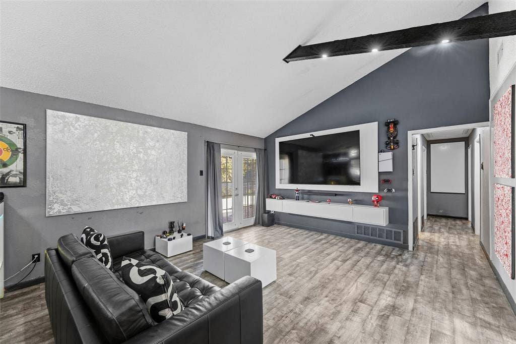 6606 Coleshire Drive, Dallas, TX 75232 Vaulted ceiling with exposed beam, recessed lighting, wood-finish flooring, and double French doors with transom windows