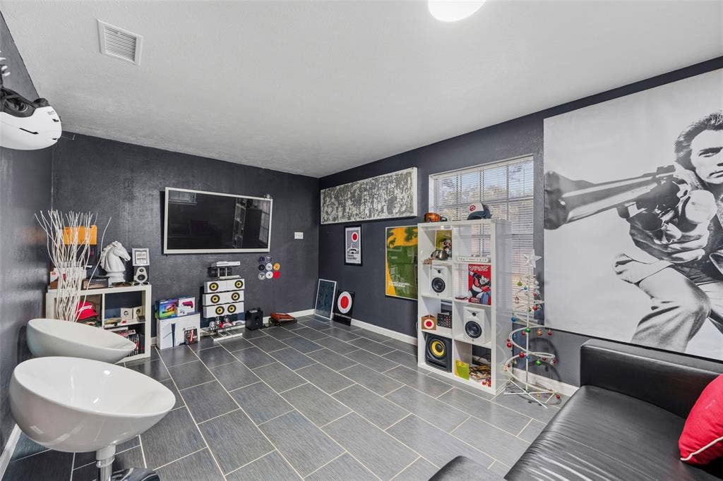 6606 Coleshire Drive, Dallas, TX 75232 Recessed lighting, tiled flooring, built-in shelving, window with natural light, and dark-toned walls