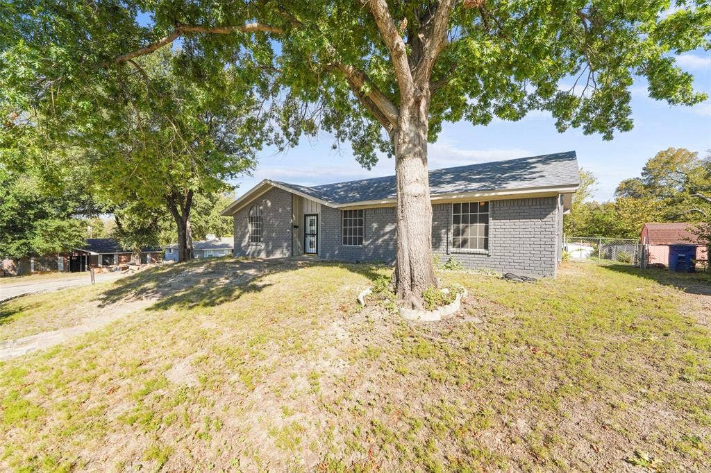 6606 Coleshire Drive, Dallas, TX 75232 Gray brick exterior with a gray shingle roof