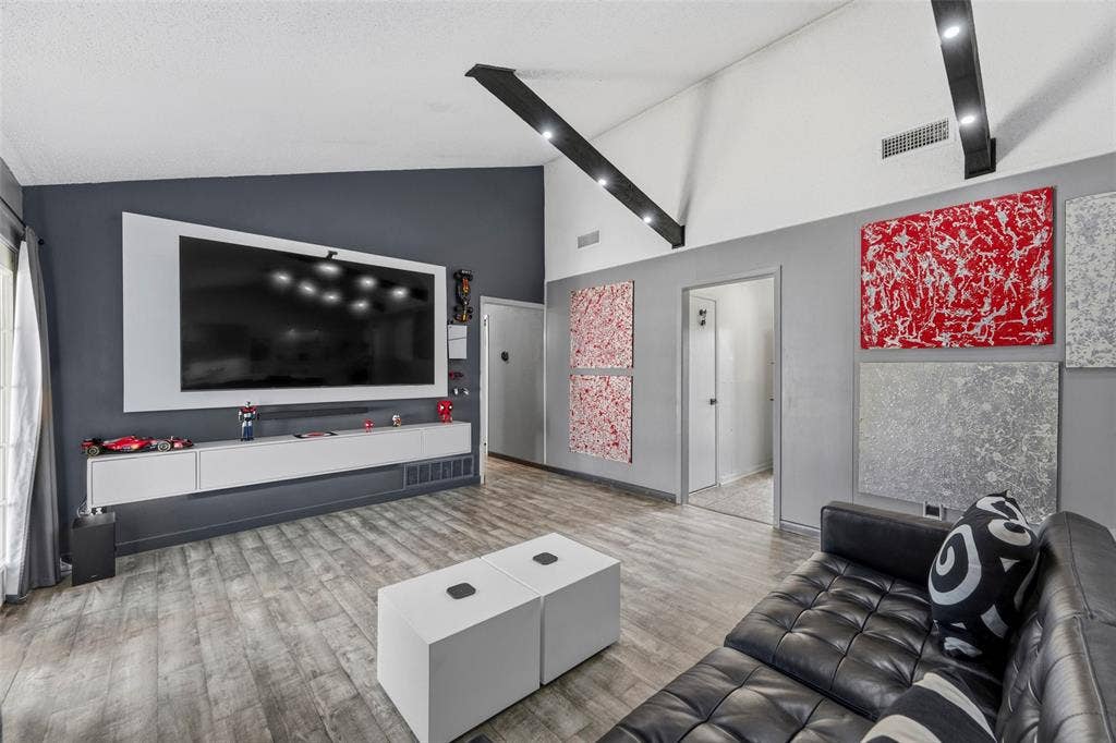 6606 Coleshire Drive, Dallas, TX 75232 Vaulted ceiling with exposed beams, wood-finish flooring, built-in media console, and recessed lighting