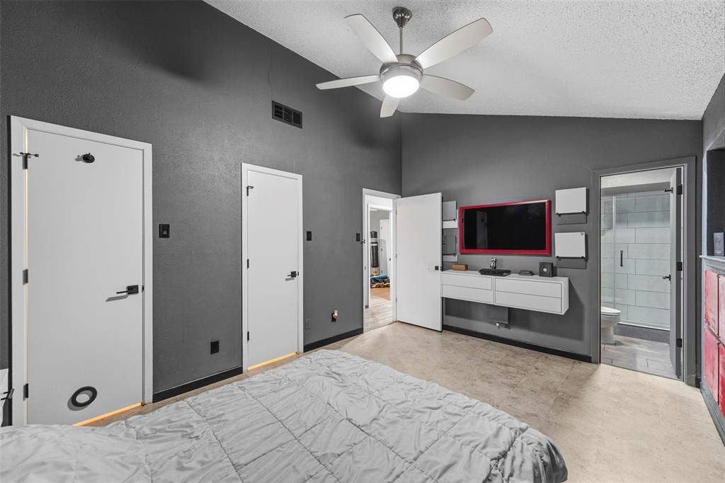 6606 Coleshire Drive, Dallas, TX 75232 Vaulted ceiling, ceiling fan, hard-surface flooring, built-in media console, and glass-enclosed shower