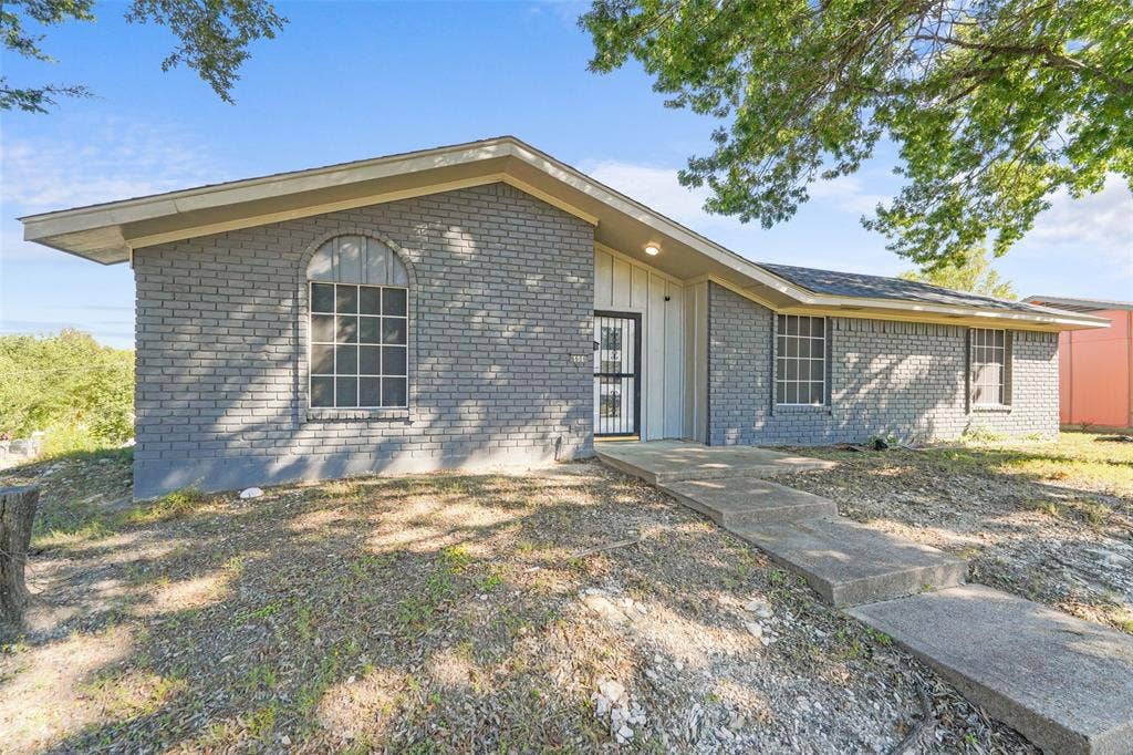 6606 Coleshire Drive, Dallas, TX 75232 Grey brick exterior with white siding accents